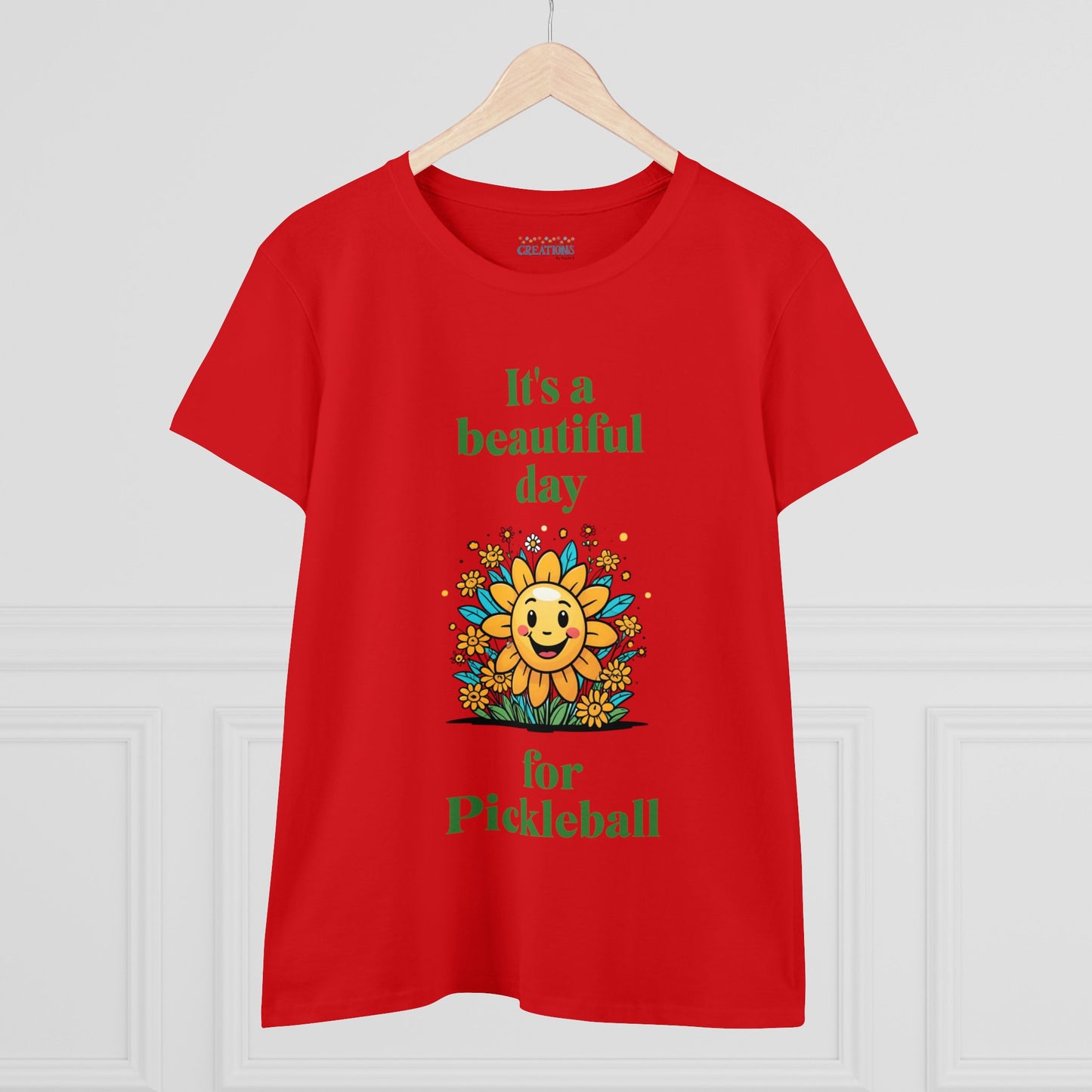 Women's Midweight Cotton Tee featuring a cheerful sun surrounded by flowers and the uplifting words, "It's a beautiful day for pickleball."