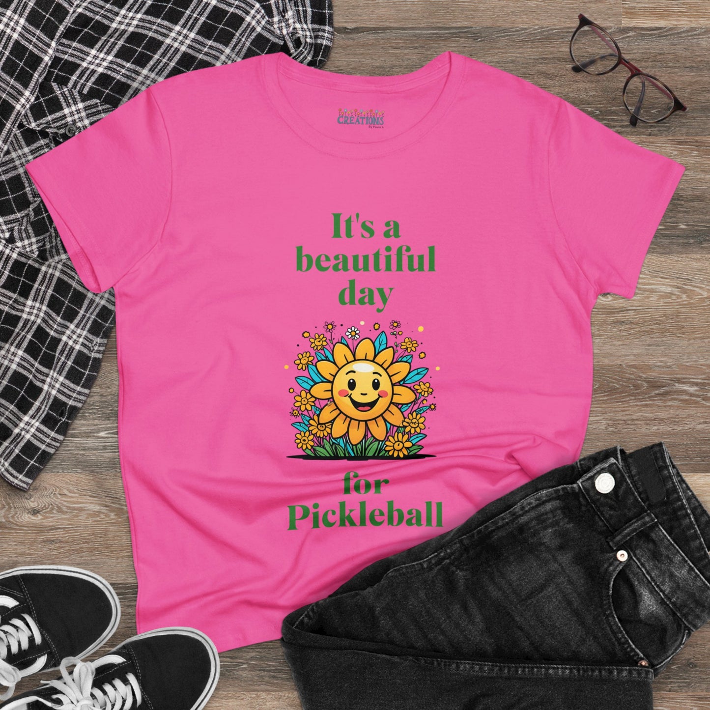 Women's Midweight Cotton Tee featuring a cheerful sun surrounded by flowers and the uplifting words, "It's a beautiful day for pickleball."