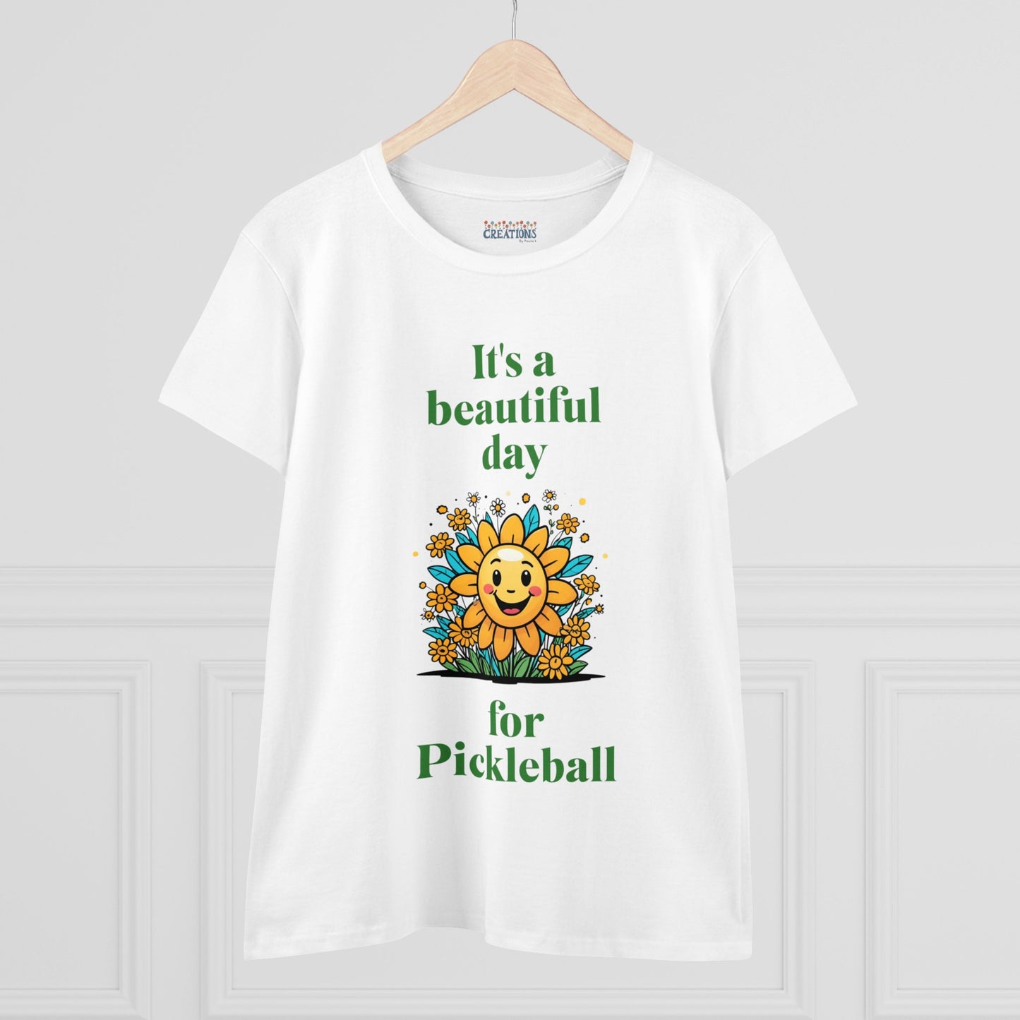 Women's Midweight Cotton Tee featuring a cheerful sun surrounded by flowers and the uplifting words, "It's a beautiful day for pickleball."