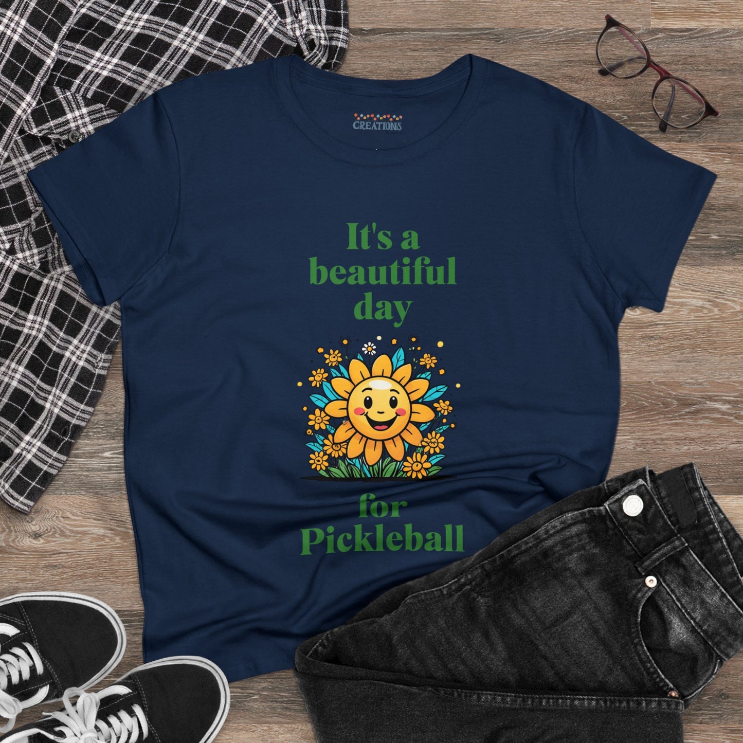 Women's Midweight Cotton Tee featuring a cheerful sun surrounded by flowers and the uplifting words, "It's a beautiful day for pickleball."