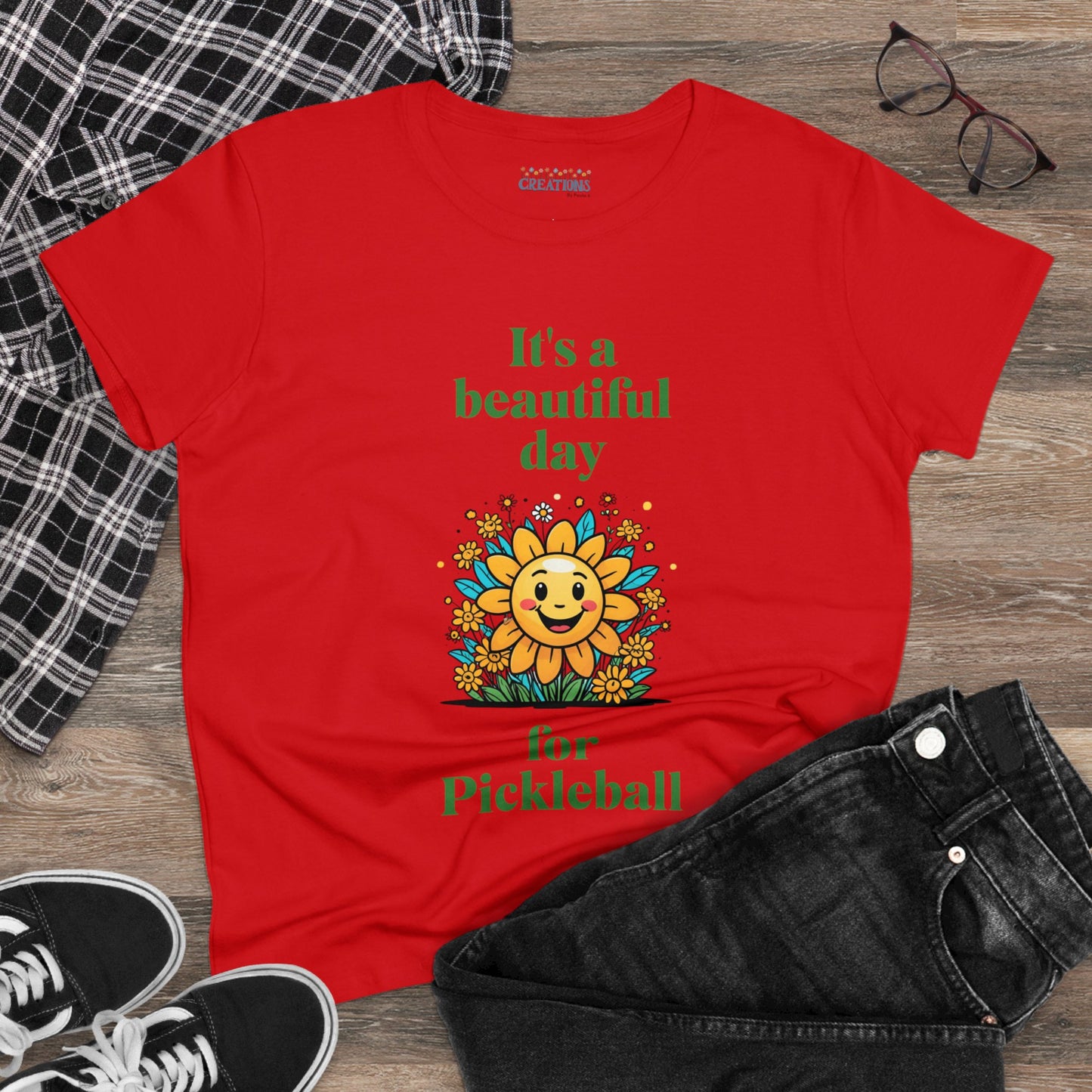 Women's Midweight Cotton Tee featuring a cheerful sun surrounded by flowers and the uplifting words, "It's a beautiful day for pickleball."