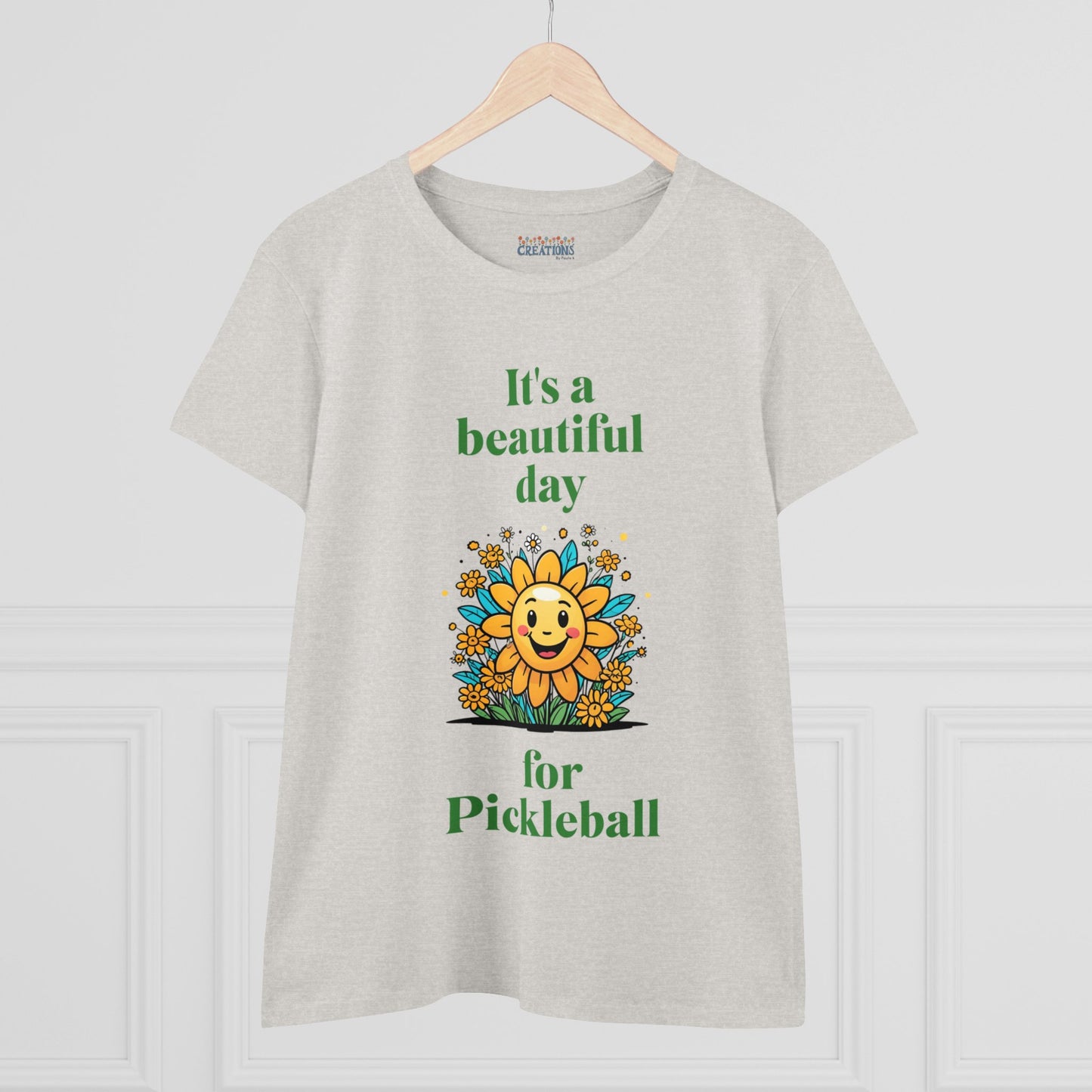 Women's Midweight Cotton Tee featuring a cheerful sun surrounded by flowers and the uplifting words, "It's a beautiful day for pickleball."