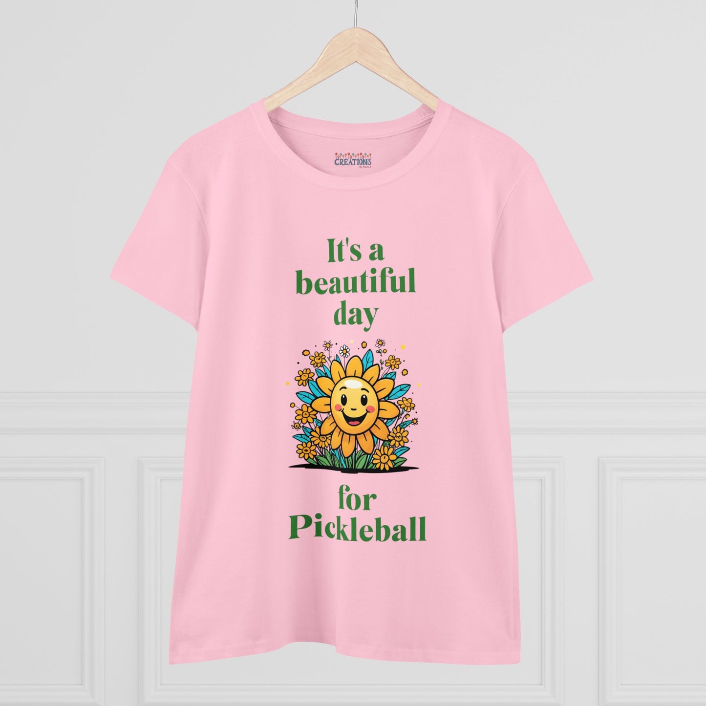 Women's Midweight Cotton Tee featuring a cheerful sun surrounded by flowers and the uplifting words, "It's a beautiful day for pickleball."