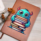 "Elegant Leather Journal – Cute Monster with Stack of Books Design"
